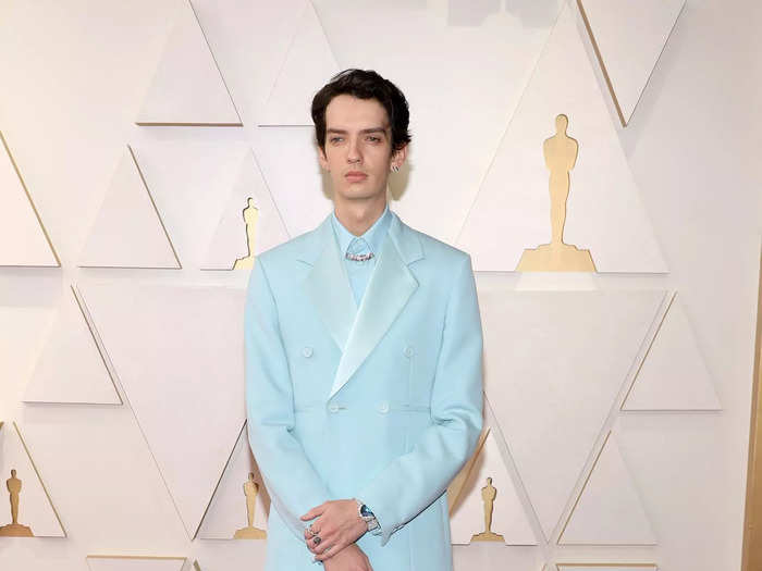 Kodi Smit-McPhee looked chic in an aqua suit and matching shirt.