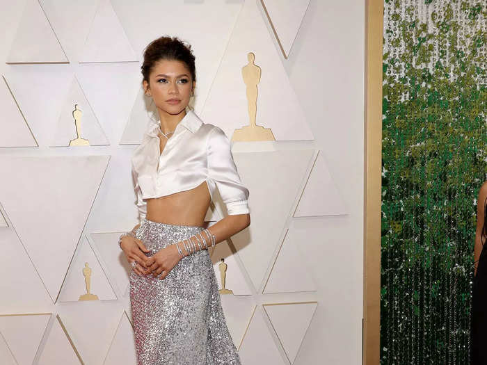 Zendaya wowed in a cropped, white blouse and high-waisted, sparkly skirt with a dramatic train designed by Valentino Haute Couture.