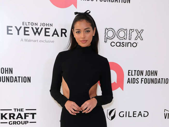 Model Cindy Kimberly walked the red carpet in a high-neck, long-sleeved Mônot dress that was backless and had scooped cutouts on each side of her waist.