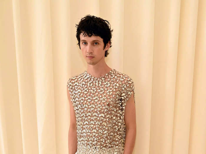 Troye Sivan opted for white pants, matching sneakers, and a see-through shirt made entirely from crystals.