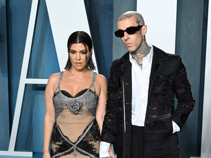 Kourtney Kardashian wore a nude and silver gown while Travis Barker opted for an oversized black coat and sunglasses.