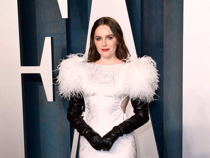 Amy Forsyth opted for a white dress which had feathery shoulder pads with cut-outs at the waist. She added long black sleeves and gloves.