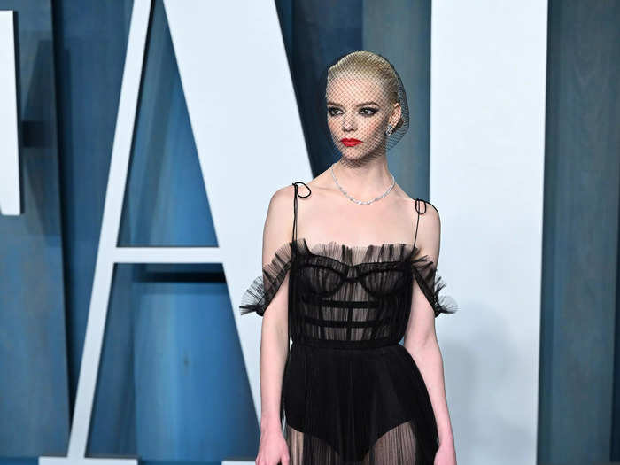 Anya Taylor-Joy wore a sheer black corset with a ruffled neckline and paired it with a netted fascinator.