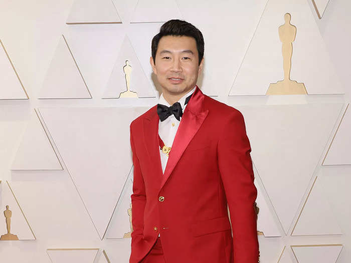 Taking to the red carpet, Oscars presenter Simu Liu stood out in a scarlet Atelier Versace suit.