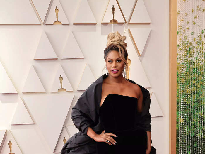 Laverne Cox opted for a striking all-black ensemble, wearing an elegant gown with a structured cape.