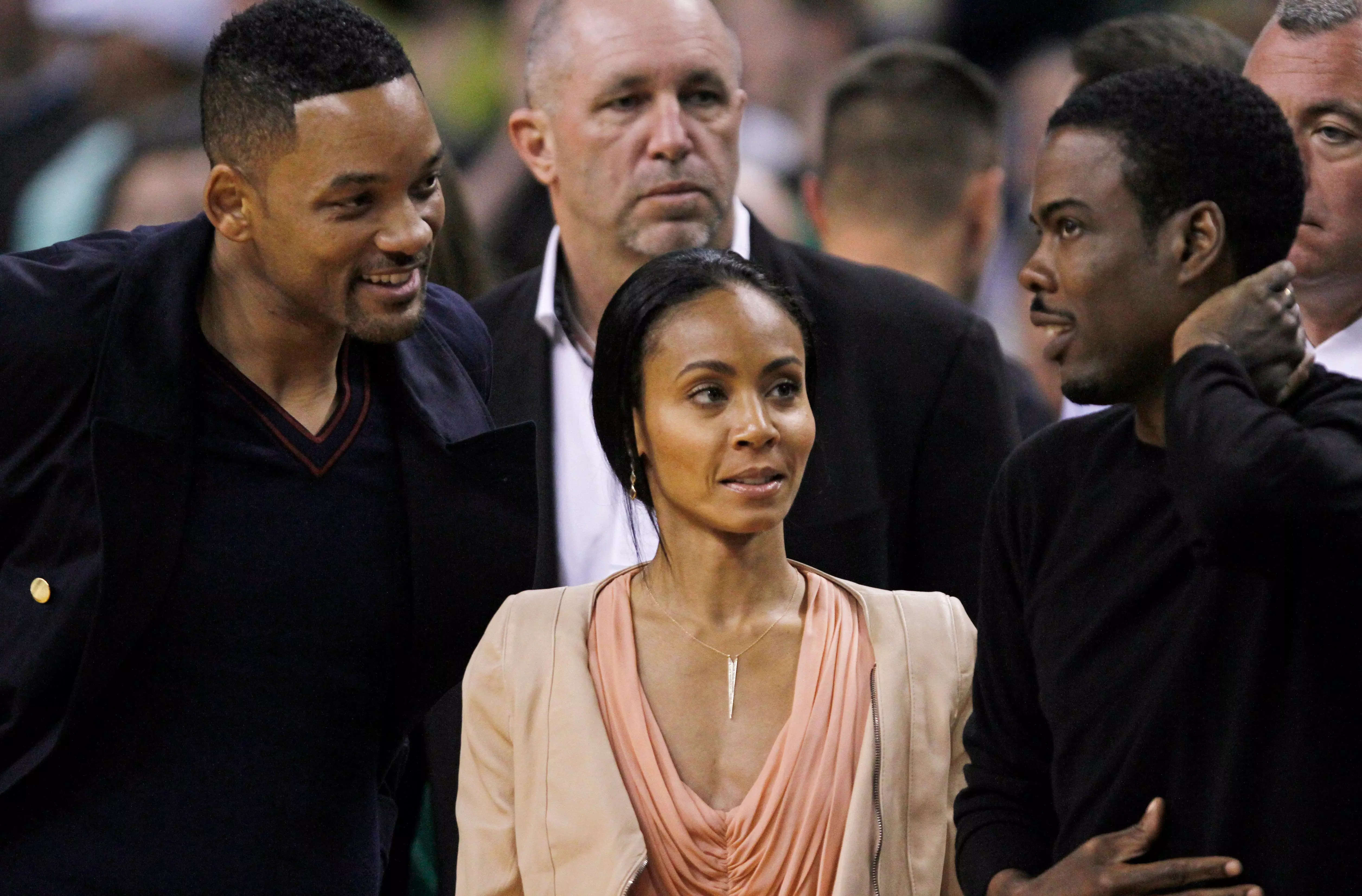 Will Smith, Jada Pinkett Smith, and Chris Rock courtside at a basketball game in May 2012.