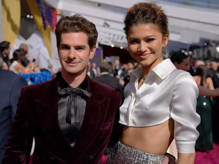 Garfield dressed in an outfit from Saint Laurent and Zendaya wore a cropped button-up blouse and glittery skirt.