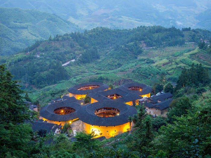 In the Fujian province of southeast China, giant fort-like structures stand among the mountains.