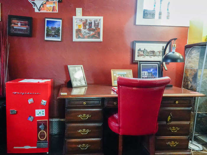 On a desk next to the fridge, I saw old photos from the bar that once was occupied this space.