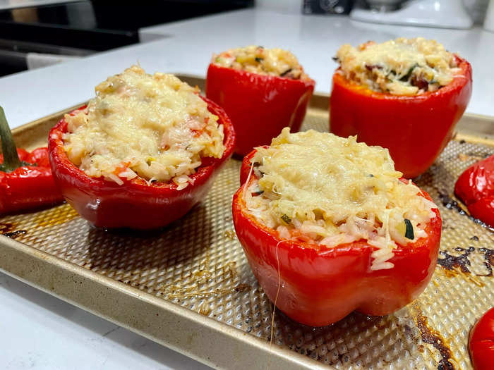 Once everything is evenly distributed, take a spoon and divide the filling among the four peppers.