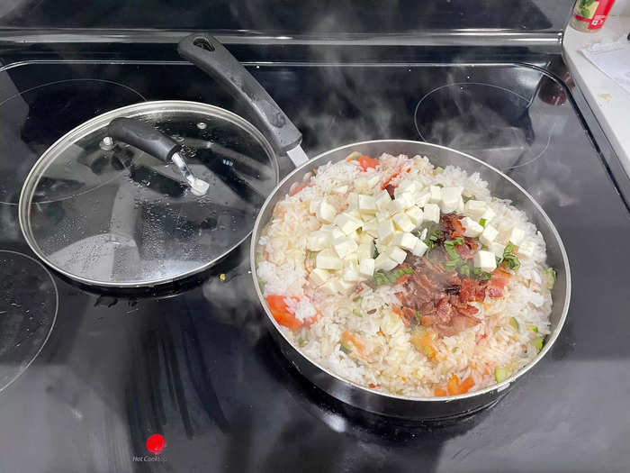 Drop the remaining ingredients into the frying pan and mix them with the rice.