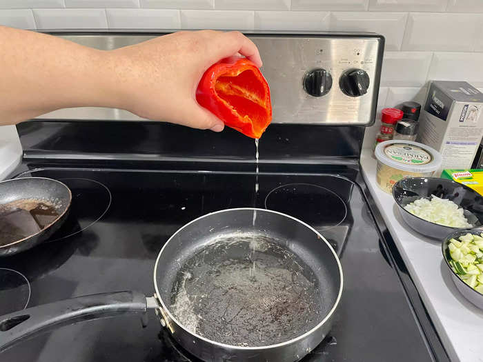 Pour the oil from the bell peppers into a frying pan.