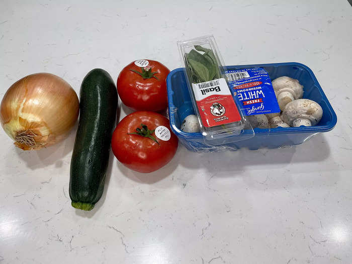 Begin prepping the vegetables, rice, bacon, and cheese bits for the stuffed bell peppers filling.