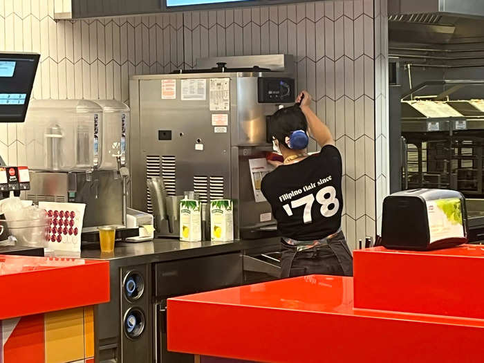 Making it appeared simple enough: A worker took a box of fries and placed them directly under the soft-serve machine.