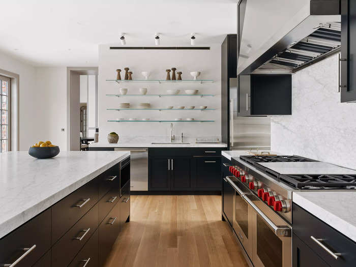 The kitchen is outfitted with modern Sub-Zero and Wolf appliances and features Carrara marble countertops.