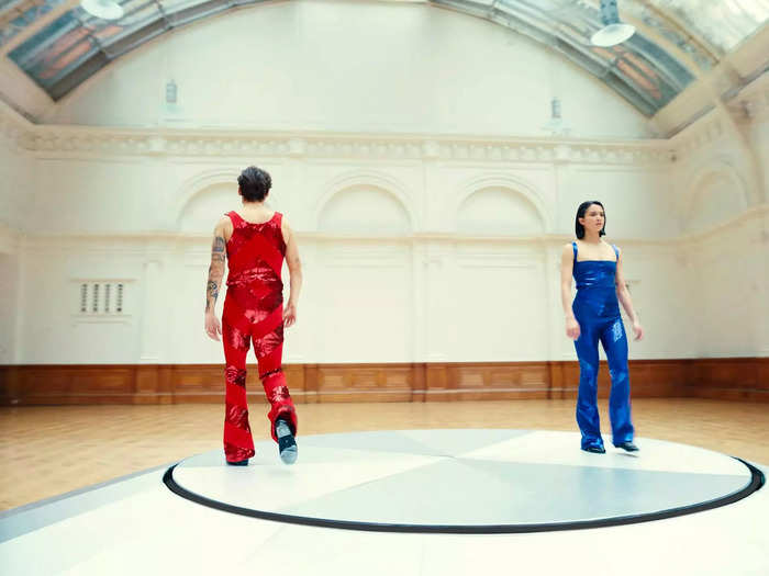 The video depicts Styles in red and a female character in blue, possibly referencing a central metaphor in "The Matrix."