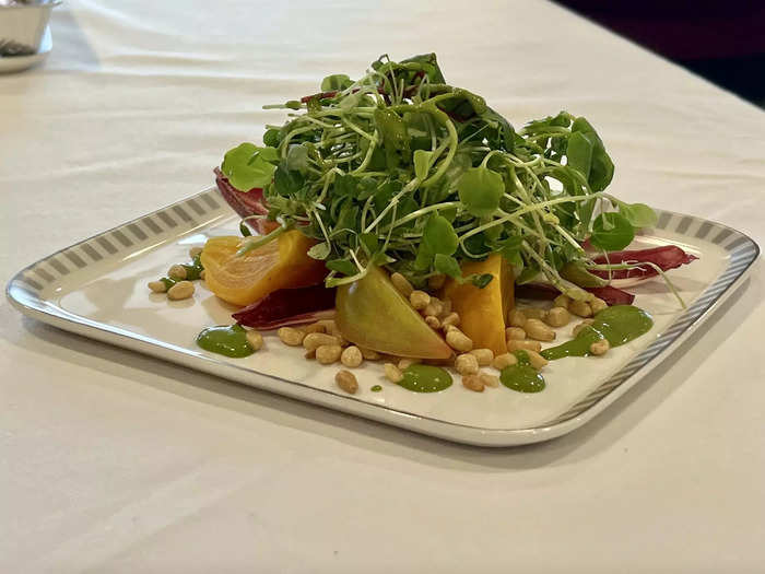 Business class appetizers and entrees include orange roasted beet salad...