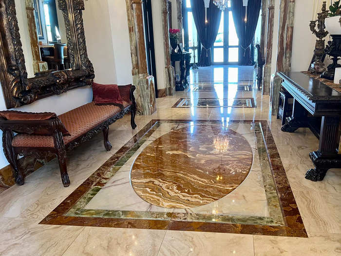 It complements the onyx book-matched floor design in the entryway, which comes from Italy, Pakistan, and Bolivia.