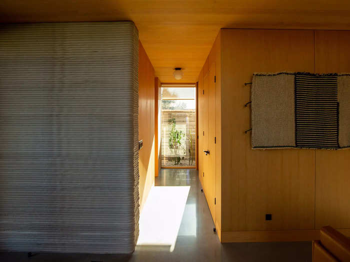 The hallway directly behind this space leads into the half-bathroom and primary bedroom.