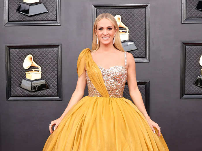 Carrie Underwood brought the glamour in gold with an embellished ball gown.