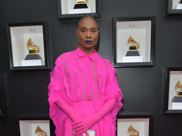 Billy Porter wore a bold fuchsia suit with ruffle details by Valentino.