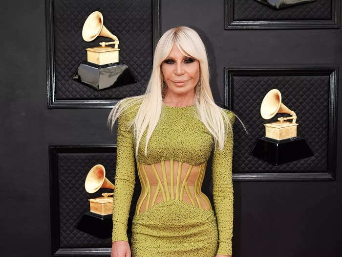 Donatella Versace walked the red carpet in a green minidress with a sheer corset bodice.