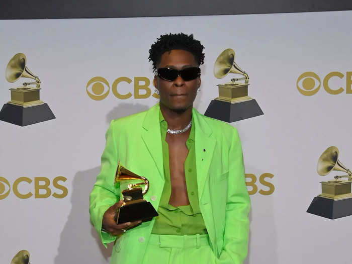 Lucky Daye posed with his Grammy award in a bright-green relaxed suit.