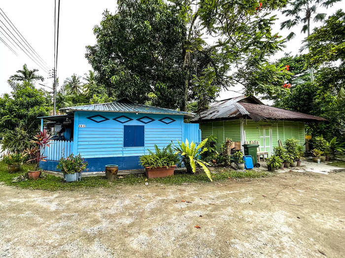 Many of the residents live in attap houses, which are common in kampongs across Southeast Asia.