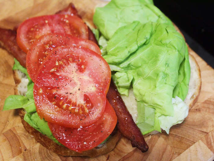 I then added four slices of tomato to the sandwich and seasoned it liberally with salt and pepper.