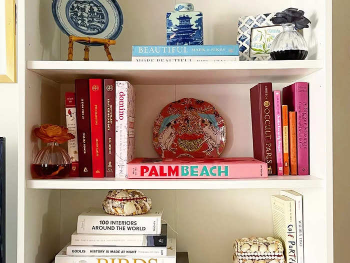 Sort books by color or remove their sleeves to add interest to your shelves.