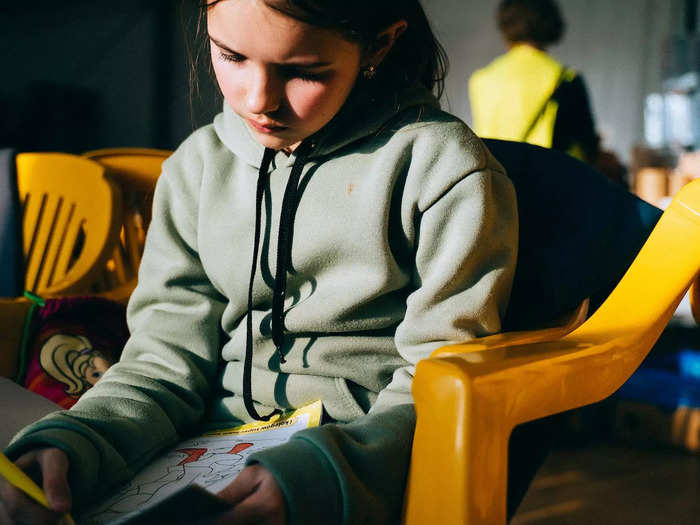 On March 17, I drove from Lublin to the Hrebrenne border crossing, where I saw a Ukrainian child drawing in a coloring book while waiting in a tent set up to shelter refugees.