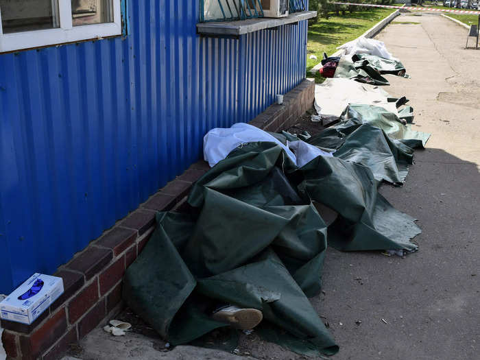 Bodies lay covered after the Russian shelling at the railway station in Kramatorsk.