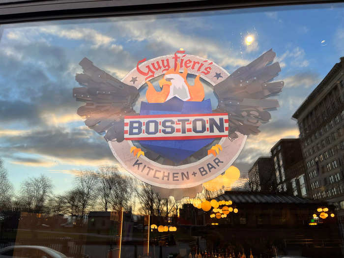 The windows are big and feature the crest of the restaurant, which seems to be a flaming bald eagle and shield.