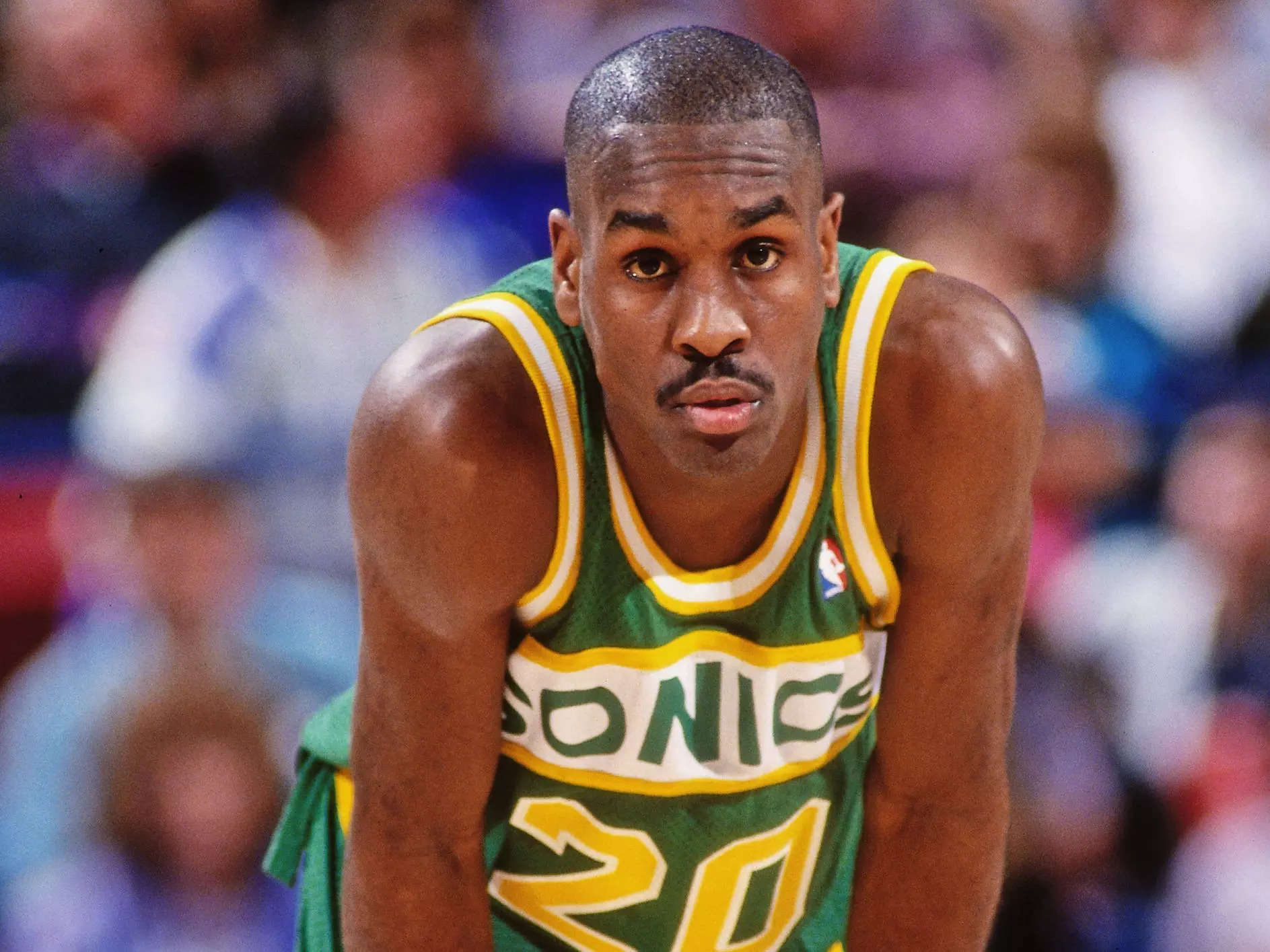 Gary Payton stands with his hands on his knees during a game in 1994.
