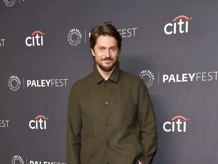 Lucas Bravo wore an oversized khaki green shirt and black work pants to the event.