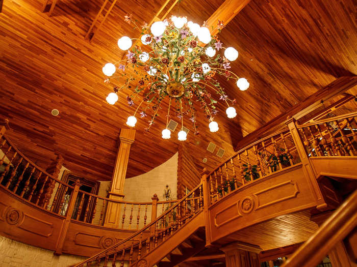 The dacha is adorned with several grandiose details, including opulent chandeliers and woodworking...