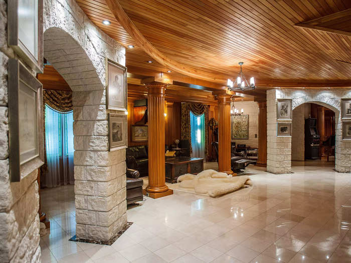 Stone columns, a fur rug, and framed photographs embellish the interior as well.