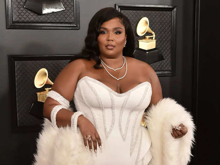 Channeling old Hollywood glamour, Lizzo wore an embellished, white floor-length gown and a cream faux-fur stole.