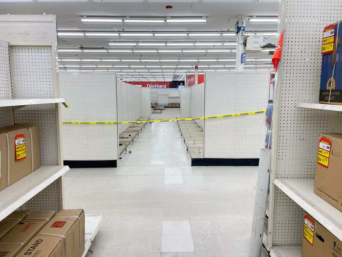 Despite the present shoppers, workers, and remaining goods, the Kmart felt coldly vacant.