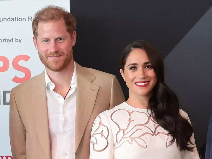 Markle ended the trip in a cream long-sleeve dress with floral cutouts and bright-red lipstick.