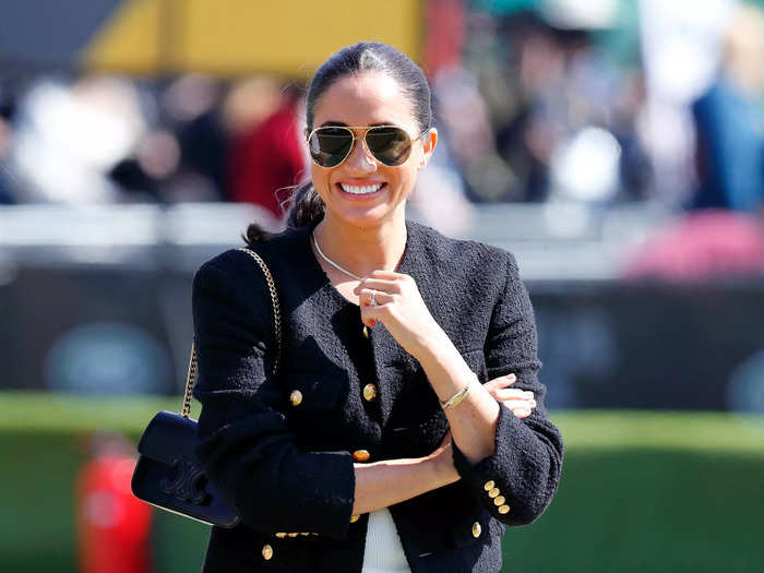 Markle wore a more relaxed look with jeans, a tweed jacket, and sunglasses to attend the Jaguar Land Rover Driving Challenge on day one.