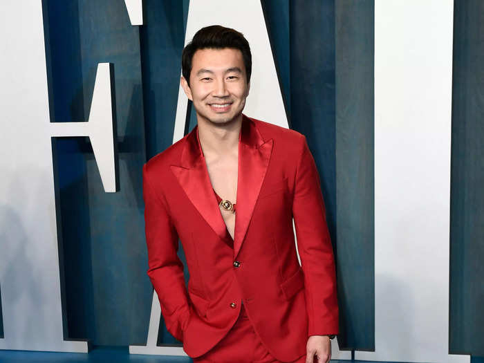 Simu Liu ditched his white shirt but kept his crimson suit at the Vanity Fair Oscar Party.