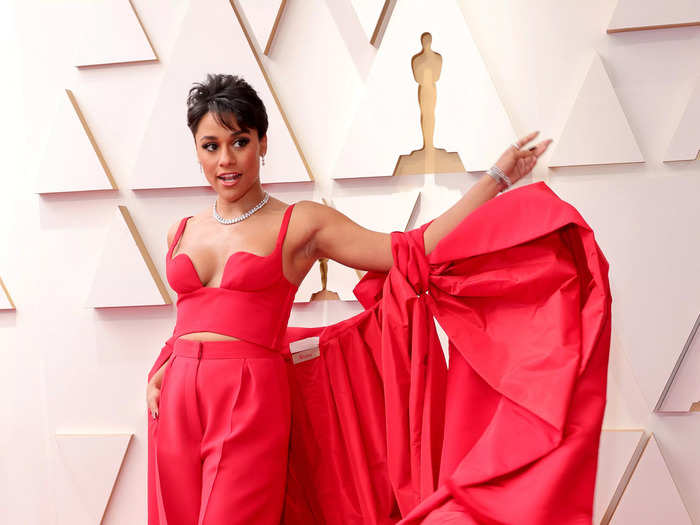 Ariana DeBose matched the Oscars red carpet in this bright-red crop top, pants, and giant cape.