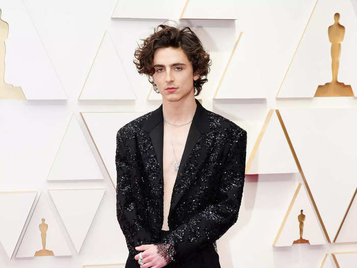 Timothée Chalamet skipped a shirt at the Academy Awards, instead opting for a black sequined jacket with lace cuffs.