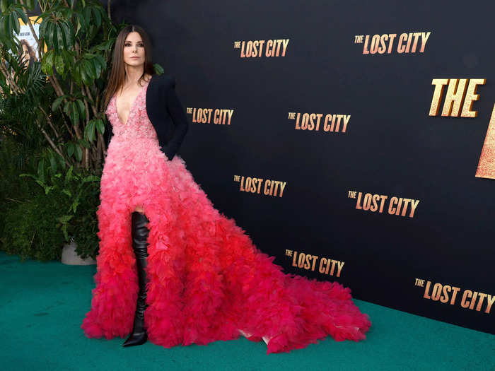 At the premiere of "The Lost City" on March 21, star Sandra Bullock wore a bright-pink ombré dress with a black blazer and thigh-high boots.