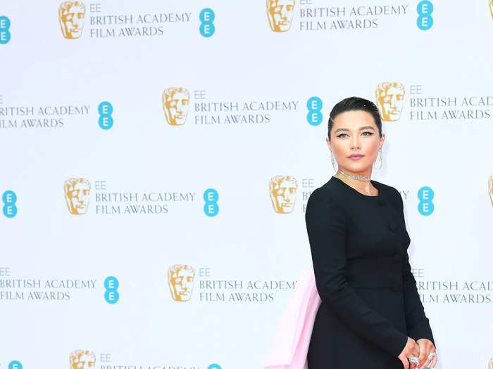 Florence Pugh attended the BAFTAs in this black minidress with an extended pink tulle train.