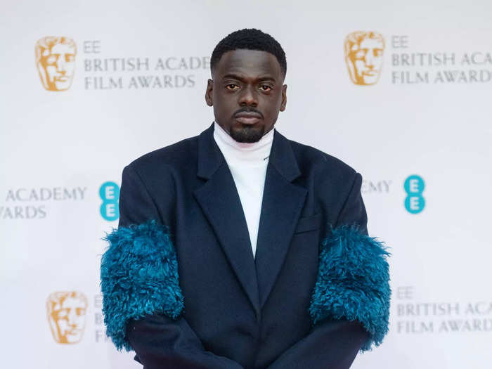 Daniel Kaluuya attended the 2022 BAFTAs in this mohair-trimmed navy overcoat and white turtleneck on March 13.