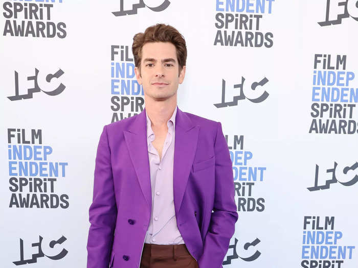 Andrew Garfield attended the Film Independent Spirit Awards on March 6 in a purple suit jacket, lavender shirt, and brown pants.