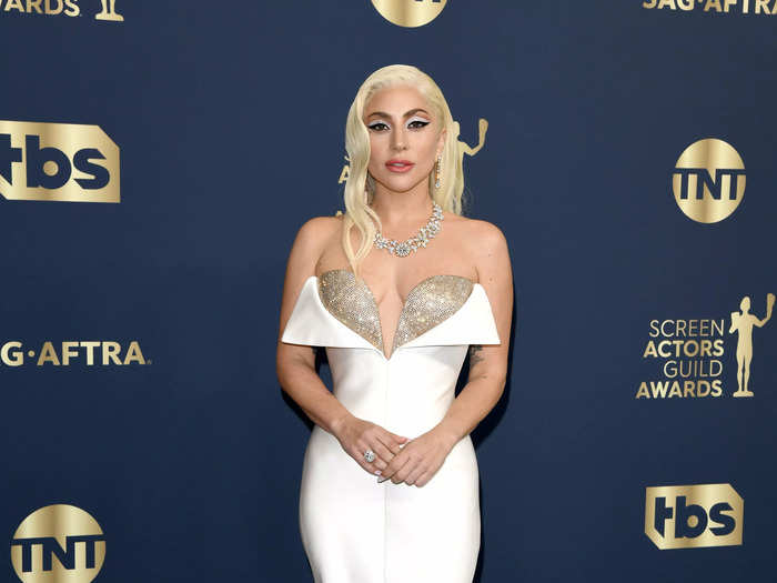 Lady Gaga wowed in this satin white gown with an exposed gold bra at the SAG Awards.