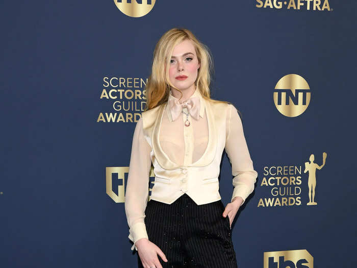 Elle Fanning rocked the menswear trend with a twist at the SAG Awards with this sheer yellow top and matching waistcoat.